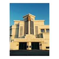 an image of a building with a golden statue on it