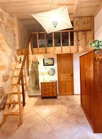 a room with a wooden staircase and a wooden bed