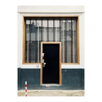a black door in front of a building