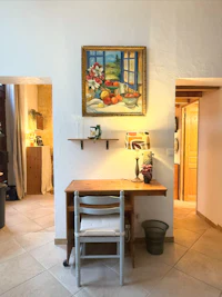 a room with a table and a painting on the wall