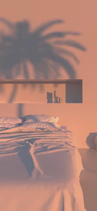 a white bed with a palm tree in the background