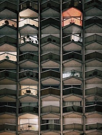 a building with many balconies and windows at night