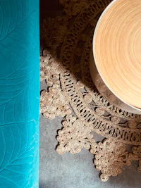 a teal chair with a rug on the floor