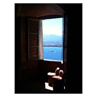 a view of the ocean through an open window
