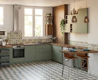 a kitchen with green and checkered tiles